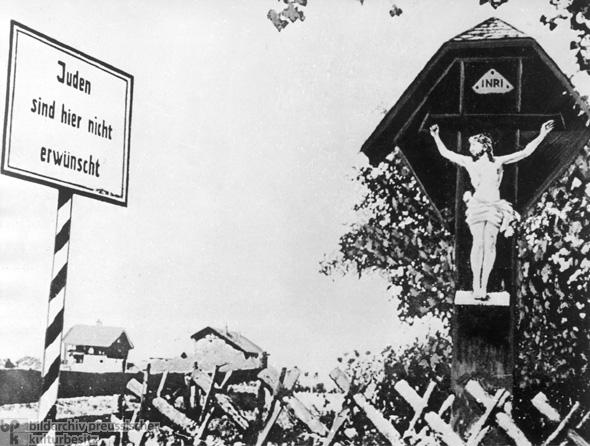 A Crucifix and an Anti-Semitic Message at the Entrance to a Franconian Village (1935)
